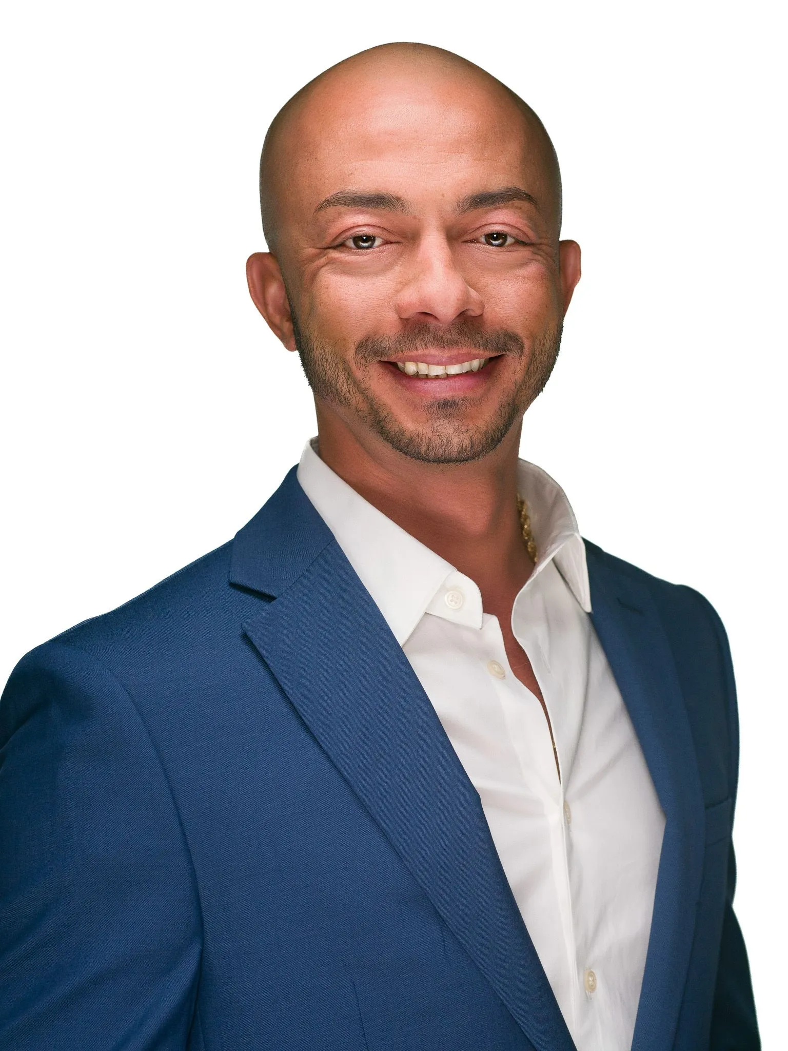 Man in a blue suit and white shirt smiling confidently against a clean white background